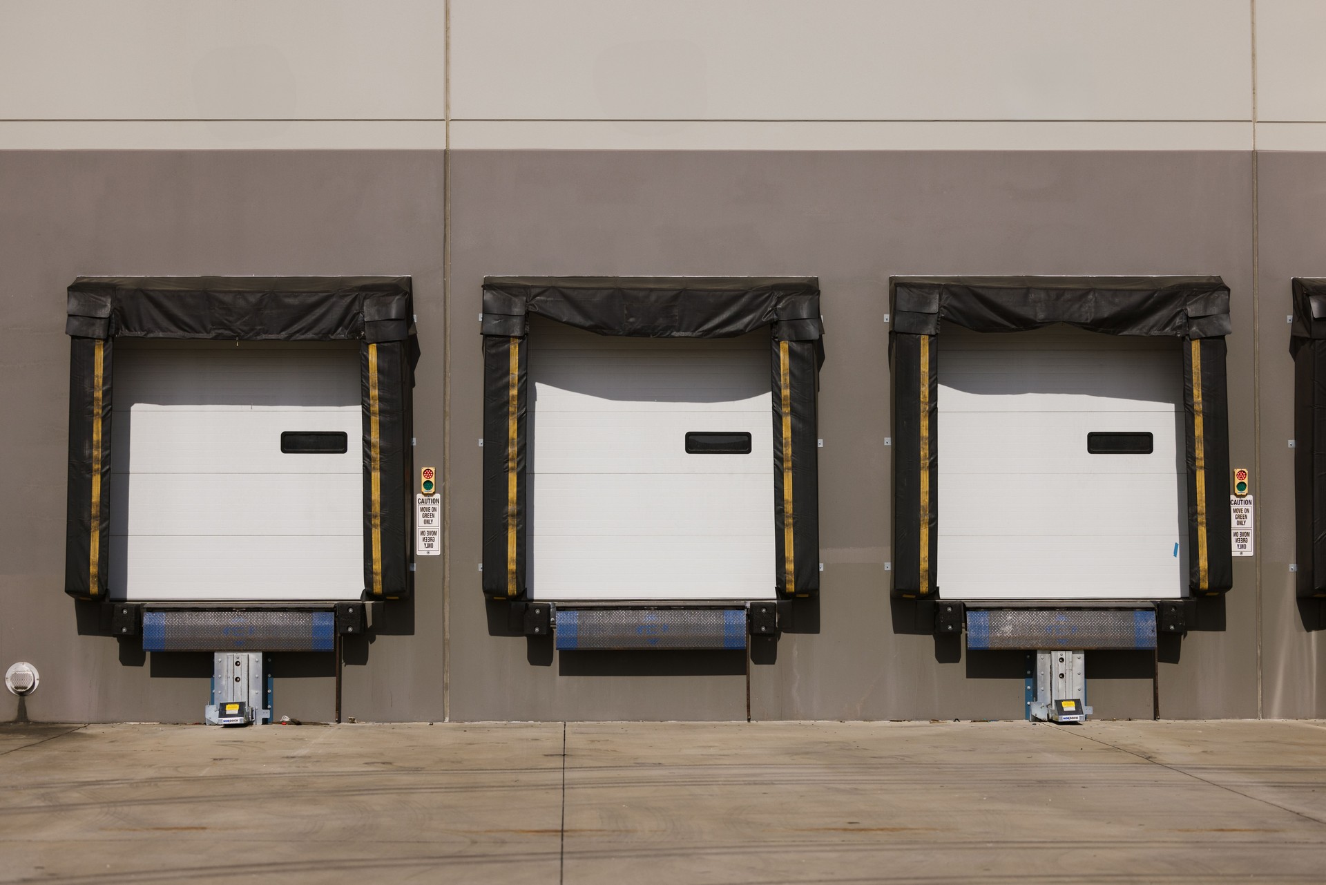 Row of Three Industrial Loading Dock Doors Front View Outdoors